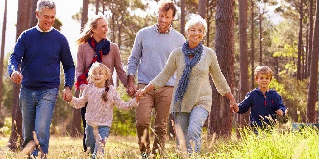Multigenerational family walking together outdoors representing life insurance protection across generations